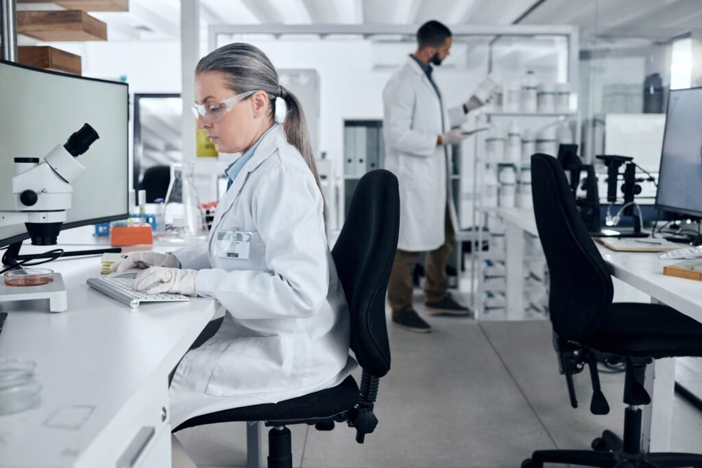 laboratory-woman-microscope-computer-typing-cancer-research-medical-healthcare-innovation-insurance-medicine-mature-dna-scientist-science-ideas-with-man-teamwork-collaboration-st
